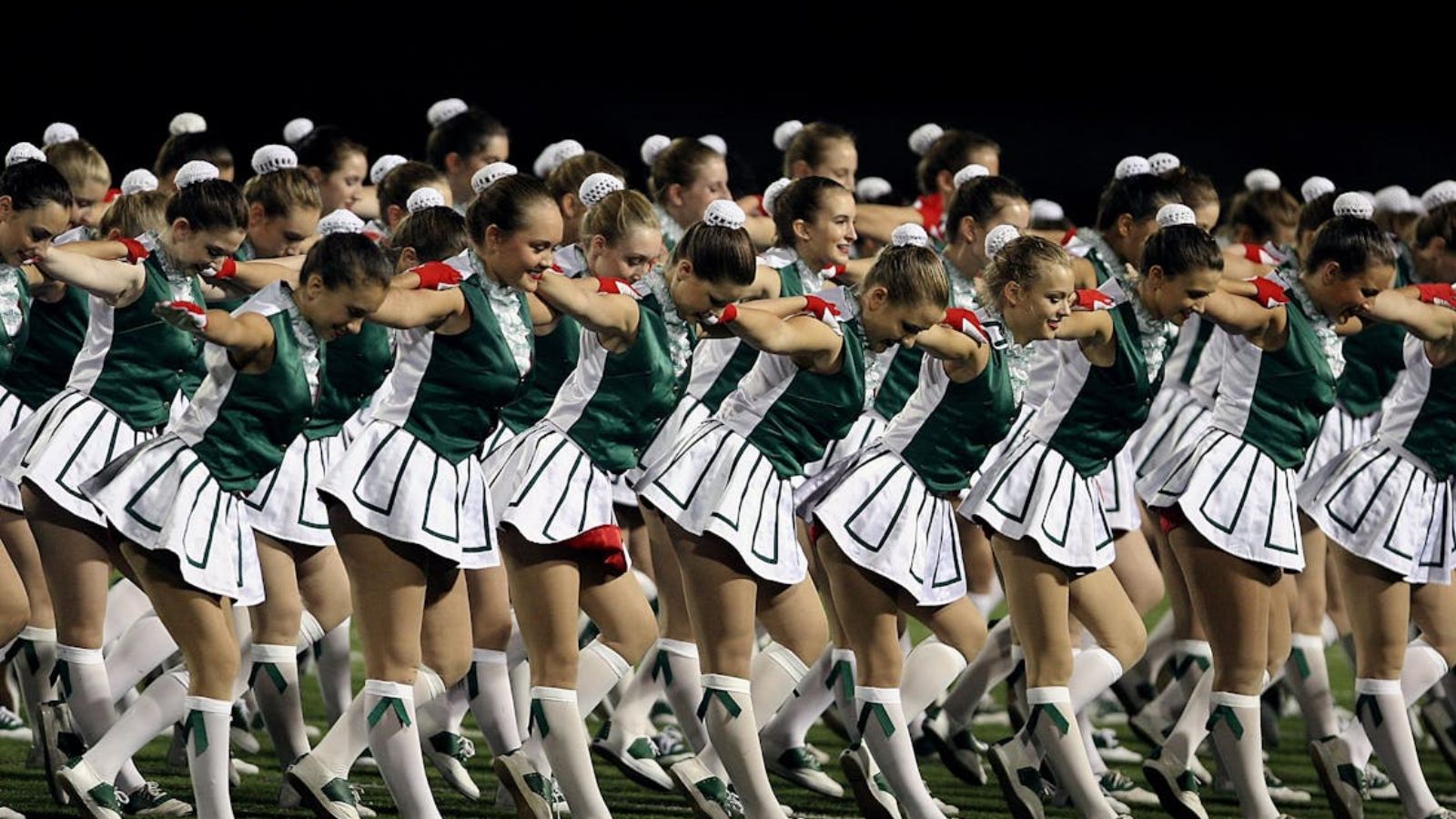 girls in green dance uniforms